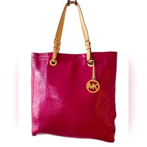 Beautiful eye catching fuscia pink patent leather tote. By Michael Kors.